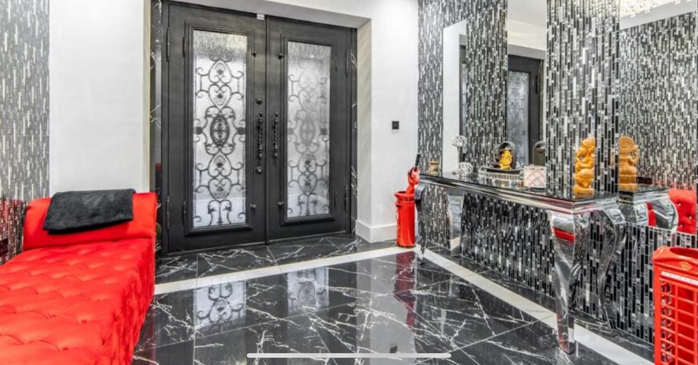 Luxury entrance hall with marble floors and ornate double doors